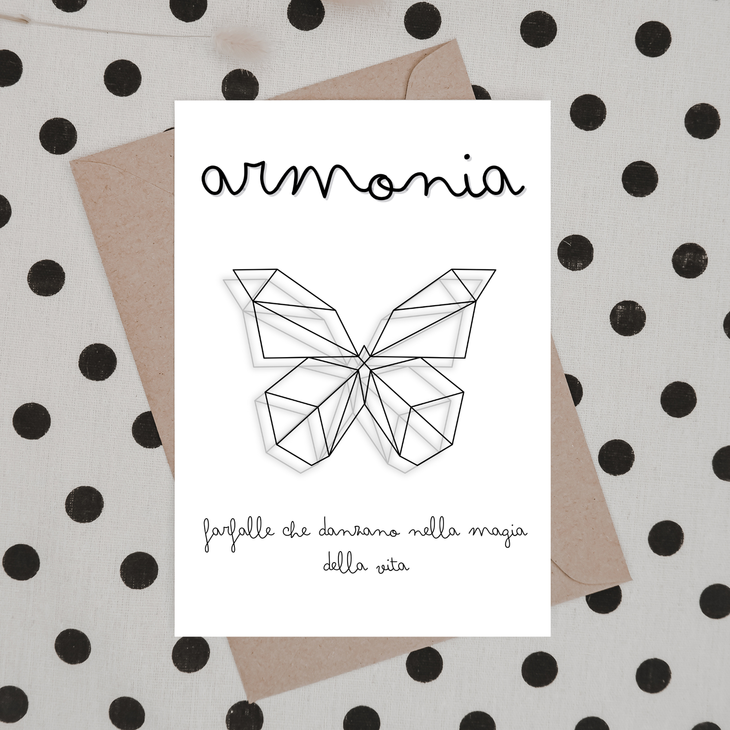 Stampa ORIGAMI INSPIRE Butterfly stampata a cartolina di invito, fotografata su piano beige con pois neri, busta avana.