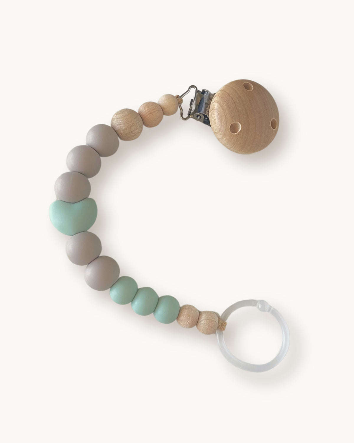 Catenella portaciuccio in silicone menta e grigio con elemento a cuore e anello trasparenti per ciuccio.