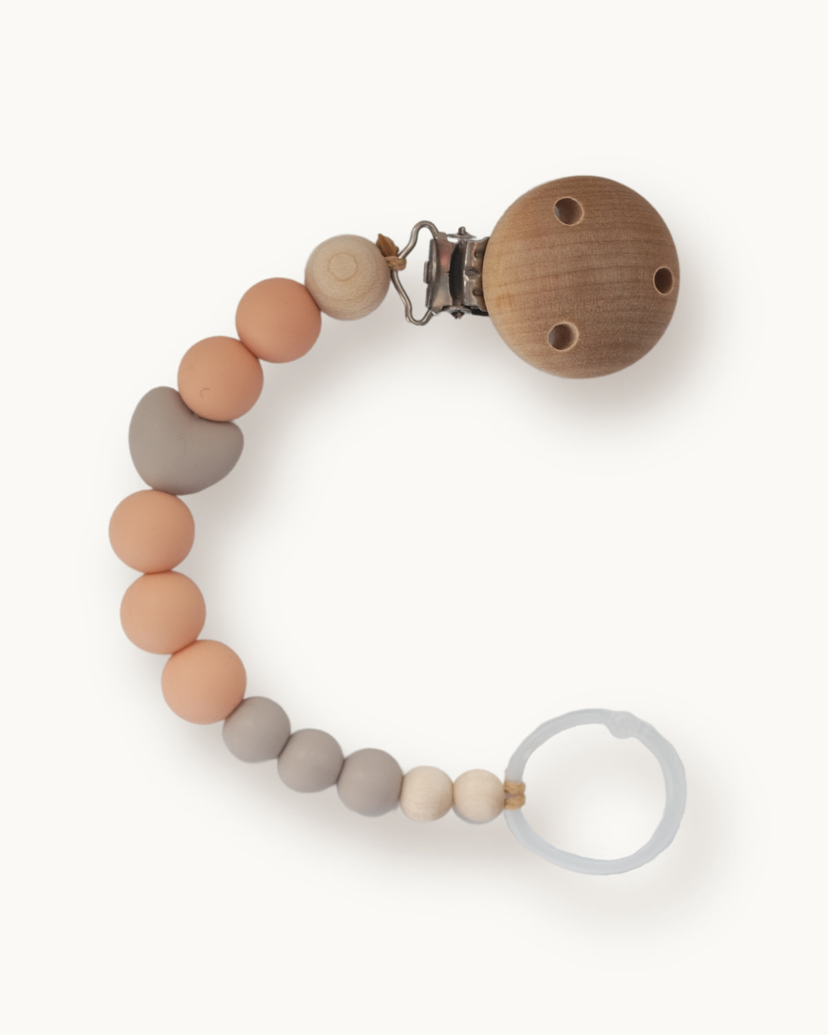 Catenella portaciuccio in silicone e legno nei toni tortora e pesca con elemento a forma di cuore e clip in legno.