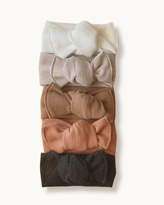 Palette di fasce per capelli da neonata in jersey di cotone nido d'ape nei colori bianco, beige, nocciola, rosa pesca e antracite
