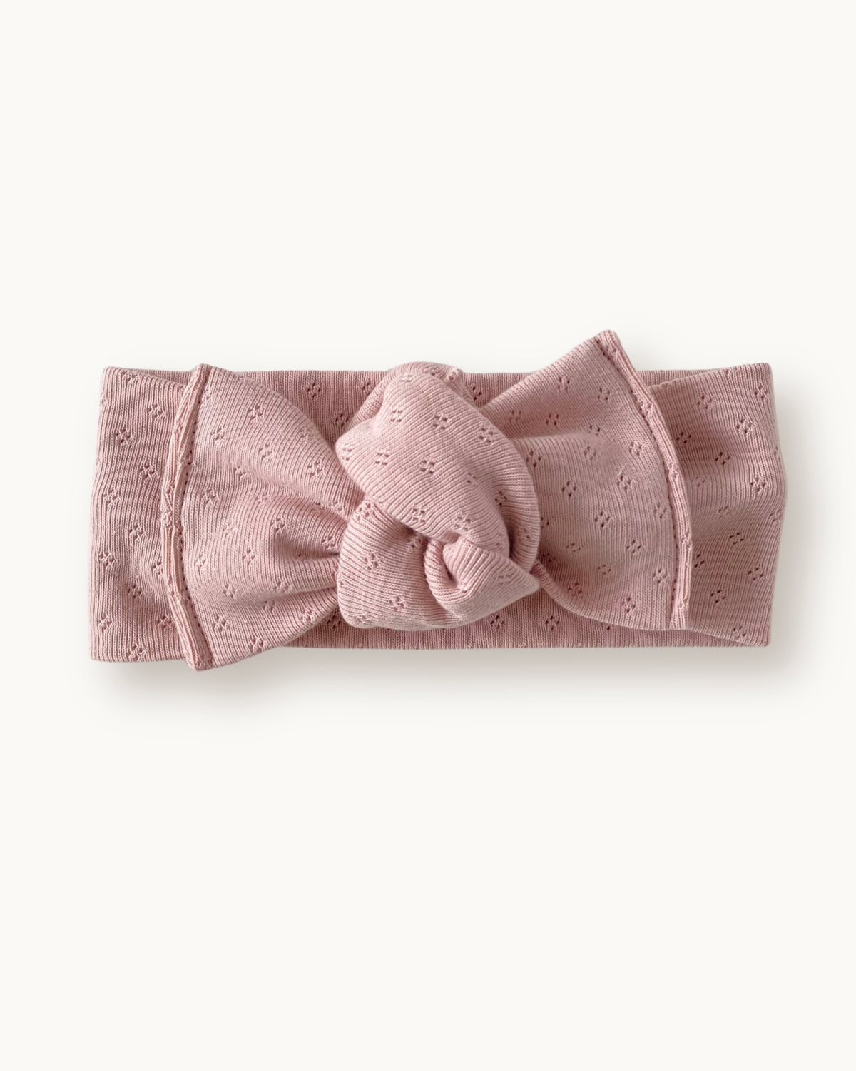 Fascia per capelli neonata con nodo in jersey di cotone pointelle colore rosa cipria