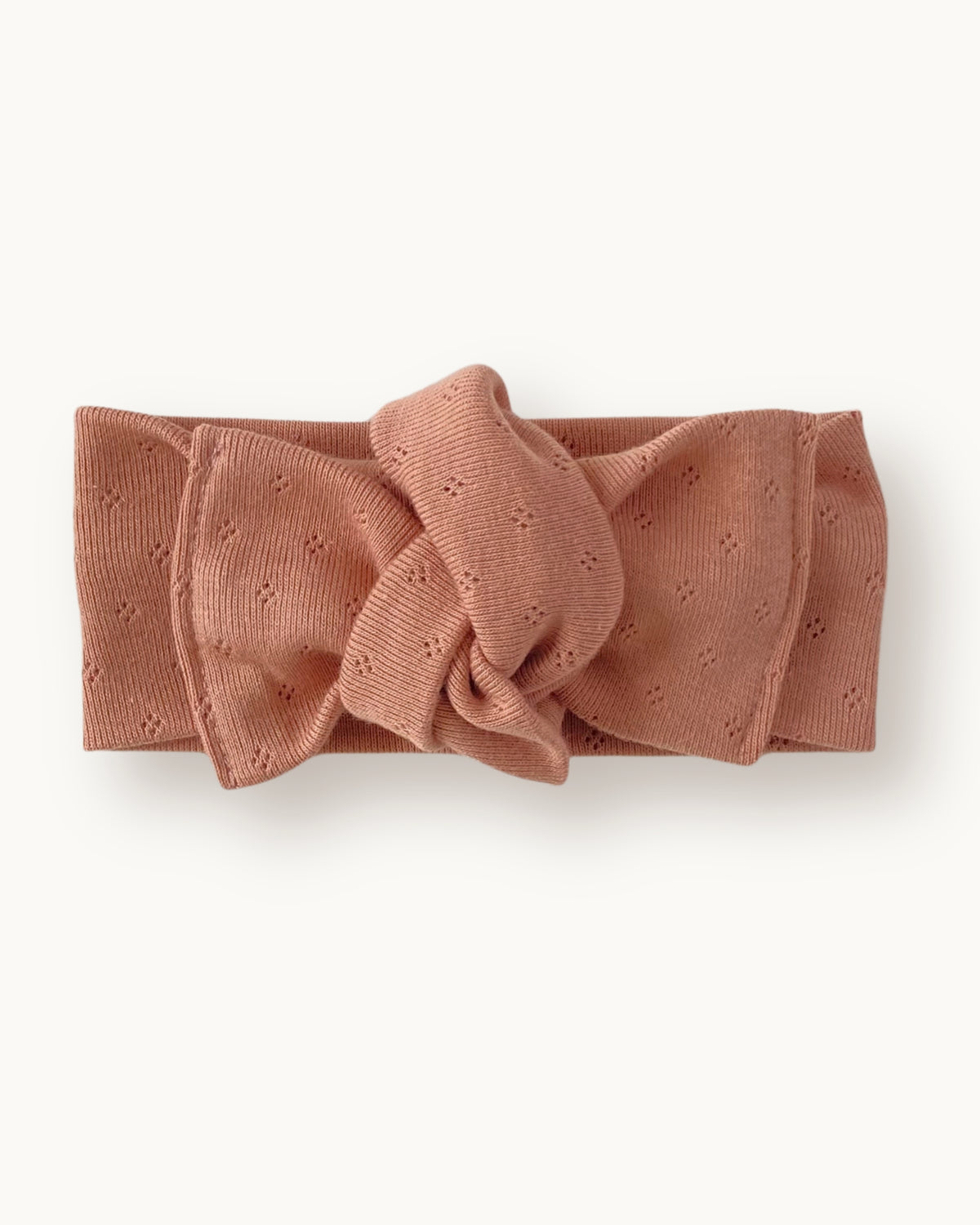 Fascia per capelli neonata con nodo in jersey di cotone pointelle colore rosa pesca