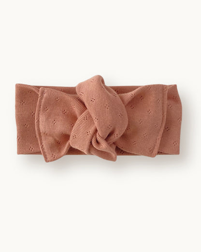 Fascia per capelli neonata con nodo in jersey di cotone pointelle colore rosa pesca