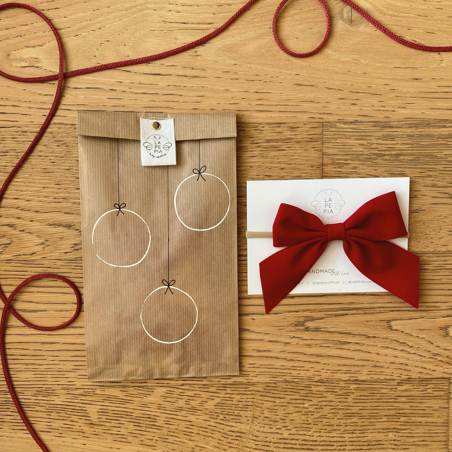 Fiocco per capelli in velluto rosso "JingleBOW" con confezione regalo in carta kraft avana decorata a mano.