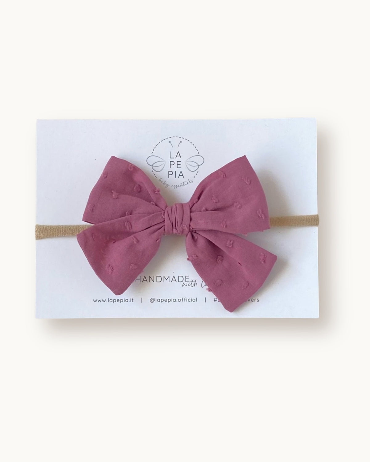 Fiocco per capelli Classic Bow in cotone plumetis colore vintage mauve su fascia elasticizzata per neonata e bambina.