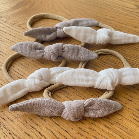 Fiocco per capelli in mussola di cotone con fascetta, nelle due varianti colore: beige e cream.